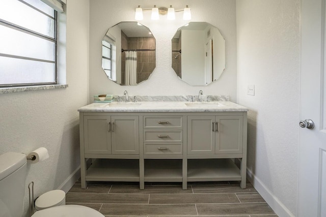 bathroom with vanity, toilet, and walk in shower