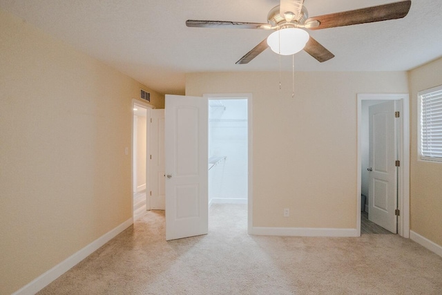 unfurnished bedroom featuring ceiling fan and light carpet