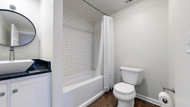 full bathroom featuring shower / tub combo with curtain, toilet, vanity, wood finished floors, and baseboards