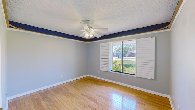 empty room featuring ceiling fan, a textured ceiling, and light hardwood / wood-style floors