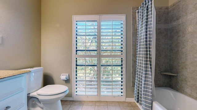 bathroom featuring toilet, shower / bath combo with shower curtain, vanity, and tile patterned floors