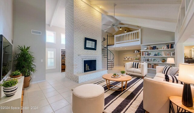 living room featuring light tile patterned floors, ceiling fan, beam ceiling, high vaulted ceiling, and a brick fireplace