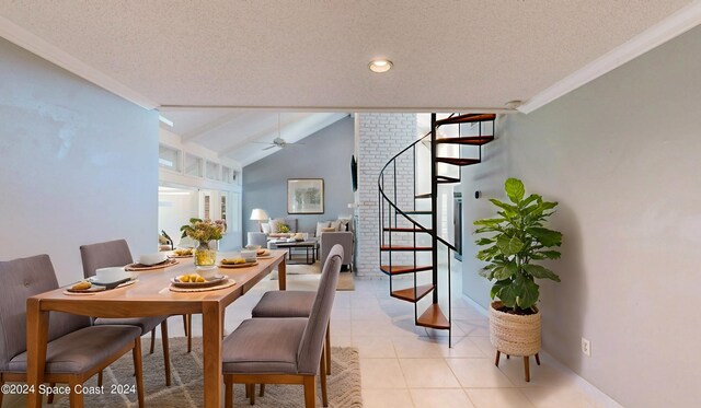 tiled dining area with crown molding, ceiling fan, vaulted ceiling, and a textured ceiling