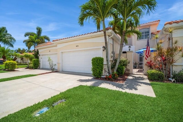 mediterranean / spanish-style house featuring a garage and a front lawn