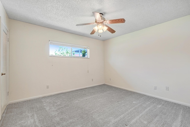 unfurnished room with carpet flooring, ceiling fan, and a textured ceiling