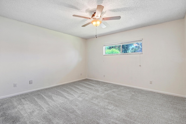 empty room featuring ceiling fan, carpet floors, and a textured ceiling