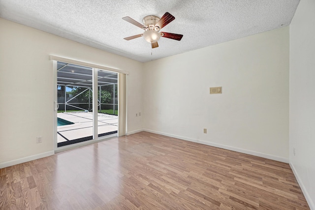 empty room featuring a textured ceiling, light hardwood / wood-style floors, and ceiling fan