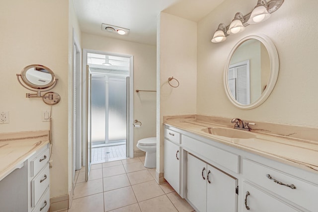 bathroom with tile patterned flooring, vanity, and toilet