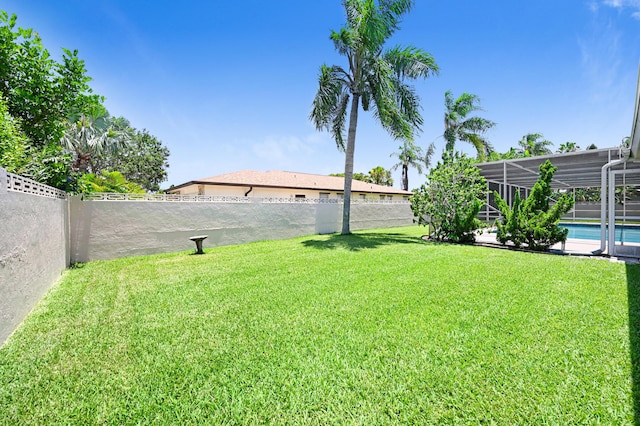 view of yard with a fenced in pool and a lanai