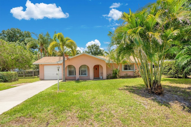 view of front of property with a front yard and a garage