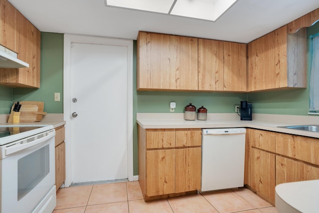 kitchen featuring sink, light tile patterned flooring, exhaust hood, and white appliances