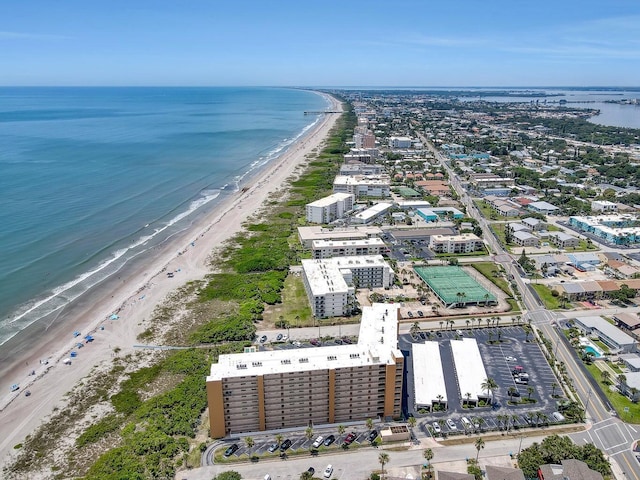 birds eye view of property with a beach view and a water view