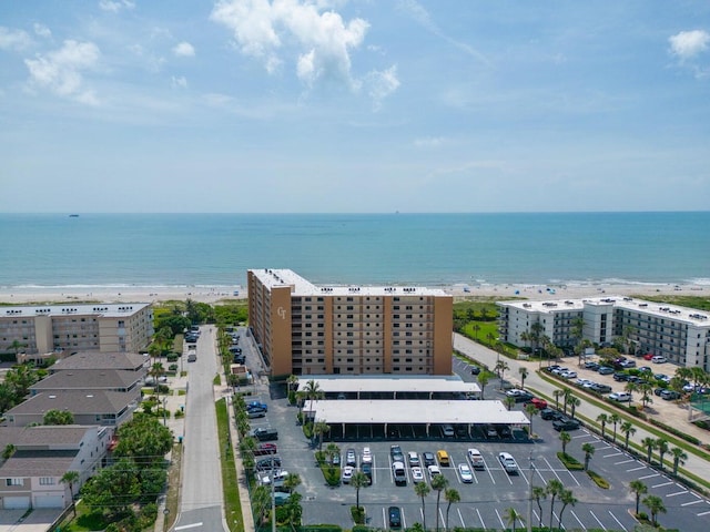 bird's eye view featuring a view of the beach and a water view