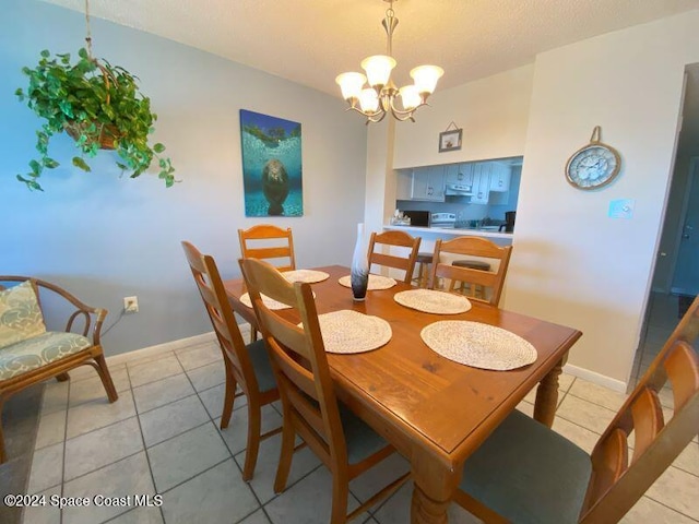 tiled dining space featuring a chandelier