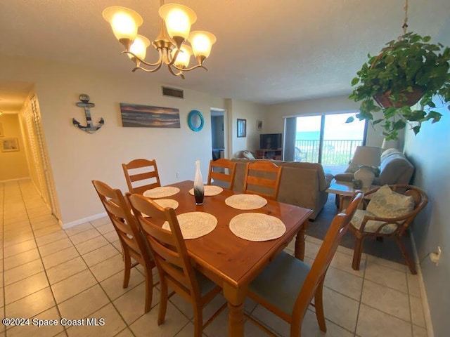 dining area with an inviting chandelier and light tile patterned floors