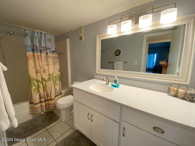 7520 Ridgewood Ave Unit 507, Cape Canaveral, FL 32920 - full bathroom with shower / bath combination with curtain, vanity, tile patterned flooring, and toilet