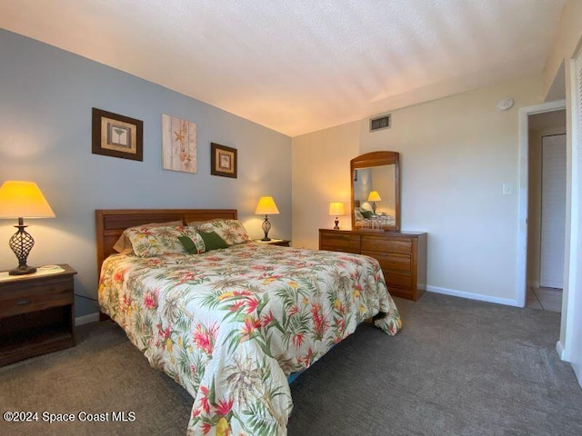 bedroom with dark colored carpet