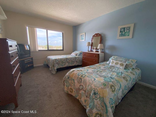 7520 Ridgewood Ave Unit 507, Cape Canaveral, FL 32920 - carpeted bedroom with a textured ceiling and baseboards
