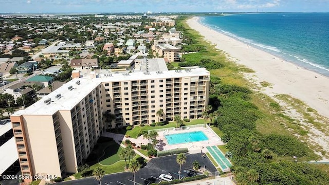 drone / aerial view featuring a water view and a view of the beach