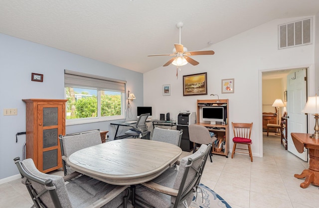 tiled dining area with lofted ceiling and ceiling fan