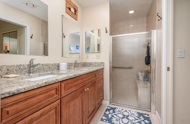 bathroom with vanity, tile patterned floors, and walk in shower