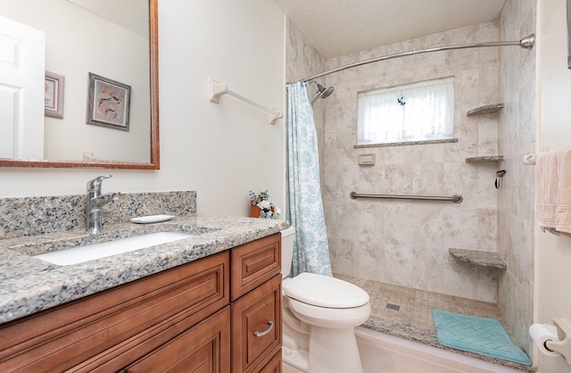 bathroom featuring vanity, curtained shower, and toilet