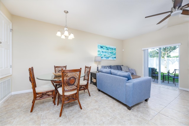 tiled dining room featuring ceiling fan with notable chandelier