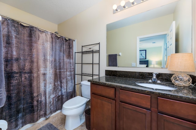 bathroom featuring tile patterned flooring, vanity, and toilet