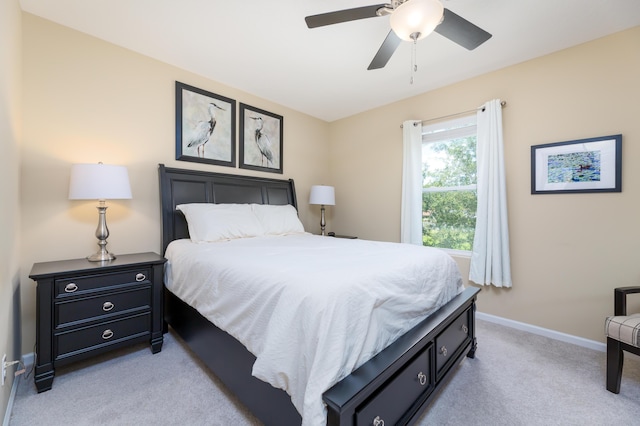 bedroom featuring light carpet and ceiling fan