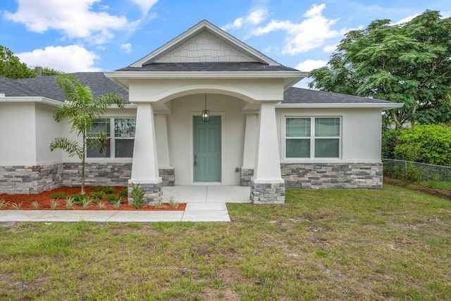 entrance to property with a lawn