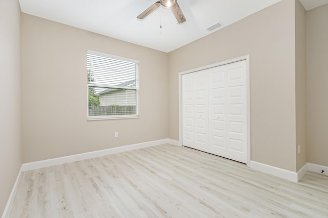 unfurnished bedroom with a closet, ceiling fan, and light hardwood / wood-style floors