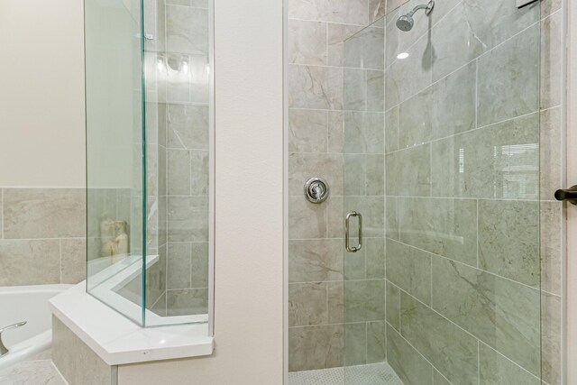 bathroom with separate shower and tub