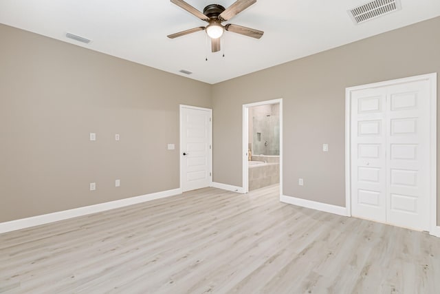 unfurnished bedroom featuring ensuite bath, light hardwood / wood-style flooring, a closet, and ceiling fan