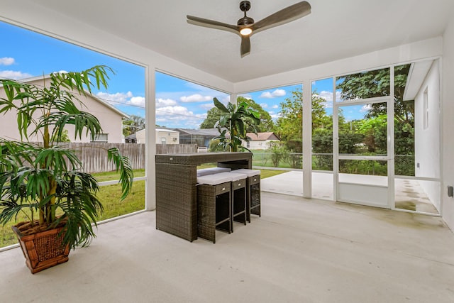 sunroom / solarium featuring ceiling fan