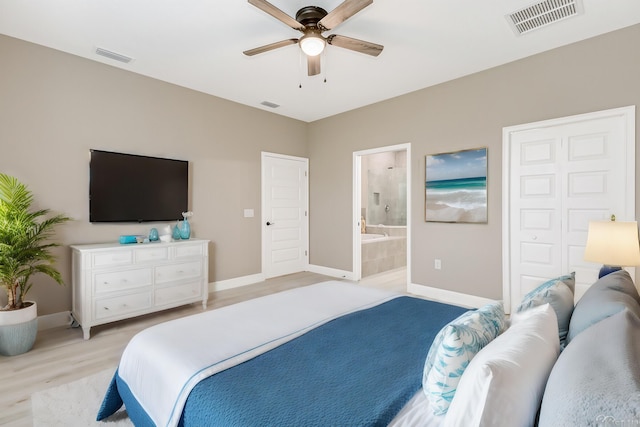 bedroom featuring ceiling fan, ensuite bathroom, and light wood-type flooring