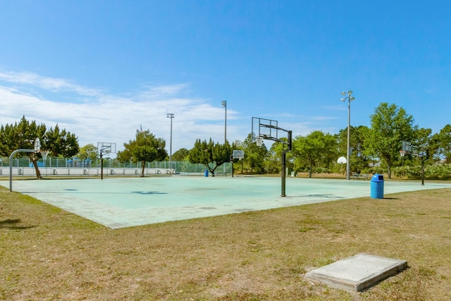 view of basketball court with a yard