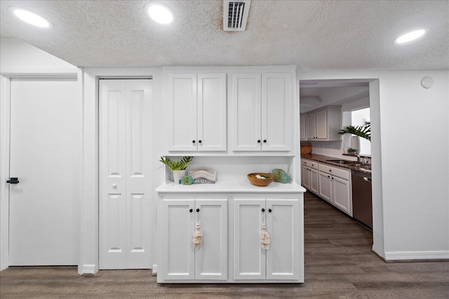 interior space featuring a textured ceiling and dark hardwood / wood-style flooring