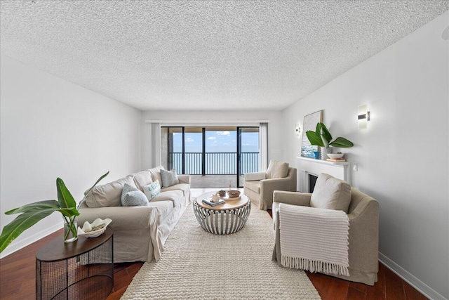 living room with dark hardwood / wood-style floors and a textured ceiling