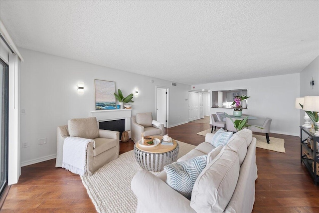 living room with a textured ceiling and hardwood / wood-style flooring