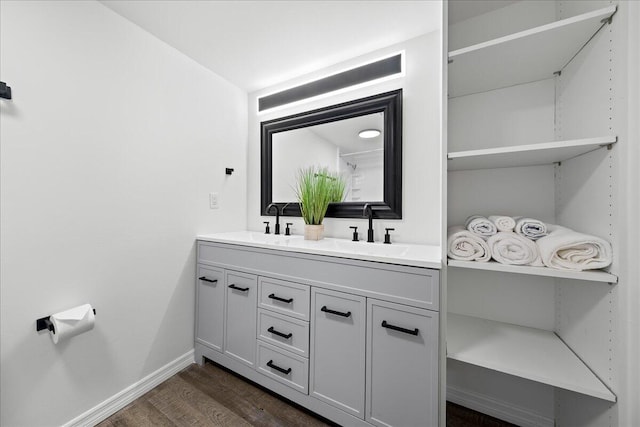 bathroom featuring dual vanity and hardwood / wood-style floors