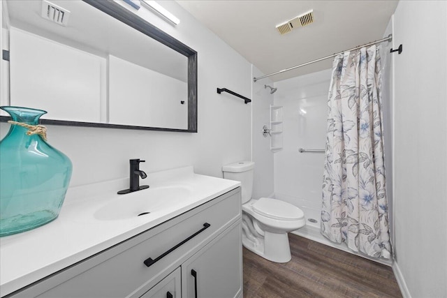 bathroom featuring vanity, toilet, and hardwood / wood-style floors