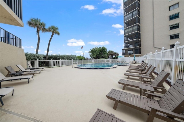 view of swimming pool featuring a patio area