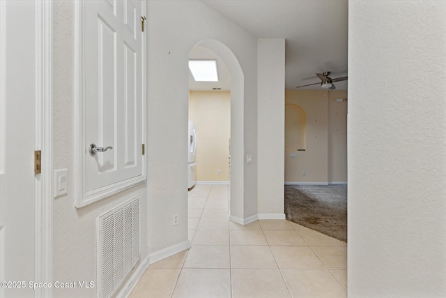 hall featuring light tile patterned flooring