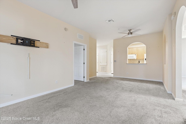 empty room featuring light colored carpet and ceiling fan