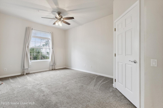 empty room with ceiling fan and carpet