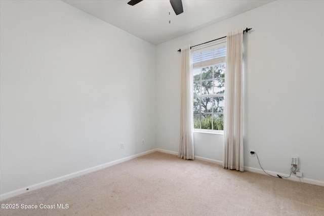 empty room featuring ceiling fan and light carpet