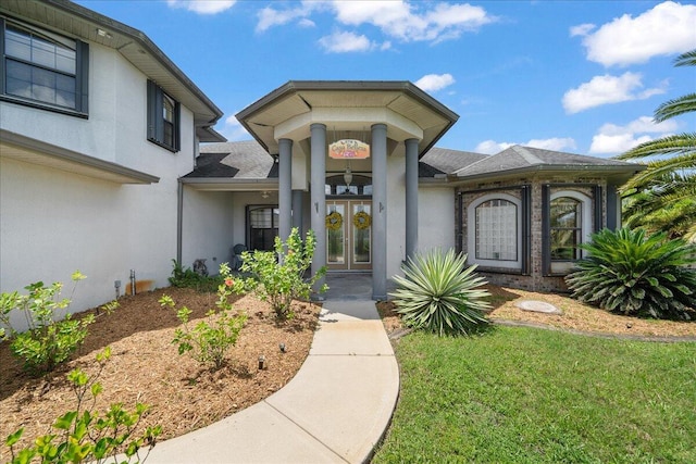 property entrance featuring french doors and a yard