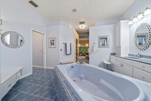 bathroom featuring tiled bath and vanity