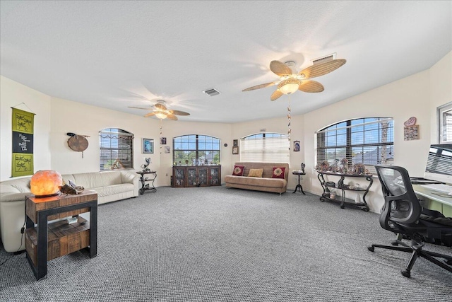 interior space featuring a textured ceiling and ceiling fan