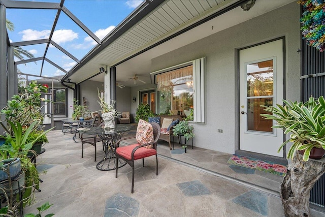 view of patio / terrace featuring glass enclosure and ceiling fan